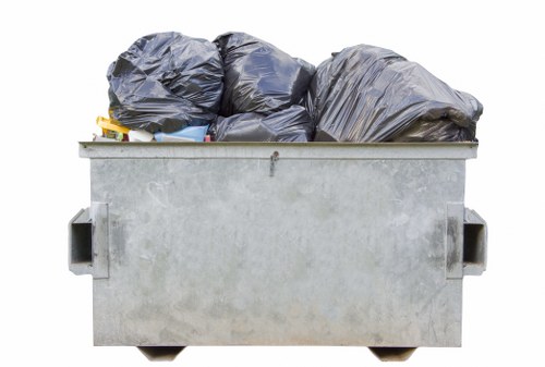 Builders placing a skip bin on a construction site in Southwark