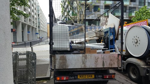 Local Southwark skip hire service vehicle delivering a skip