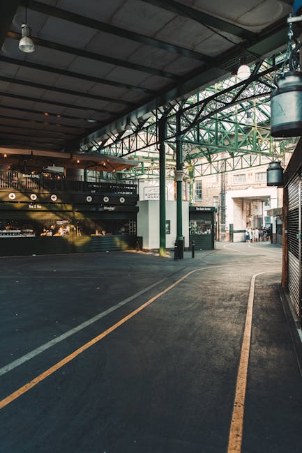 The exterior of Borough Market is visible in the image, featuring an ornate green iron framework supporting a large white sign with bold, dark green lettering that reads 'BOROUGH MARKET.' The sign is 
